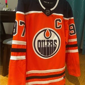 Adidas orange and Blue addidas authentic NHL Jersey with tie down size 50.
